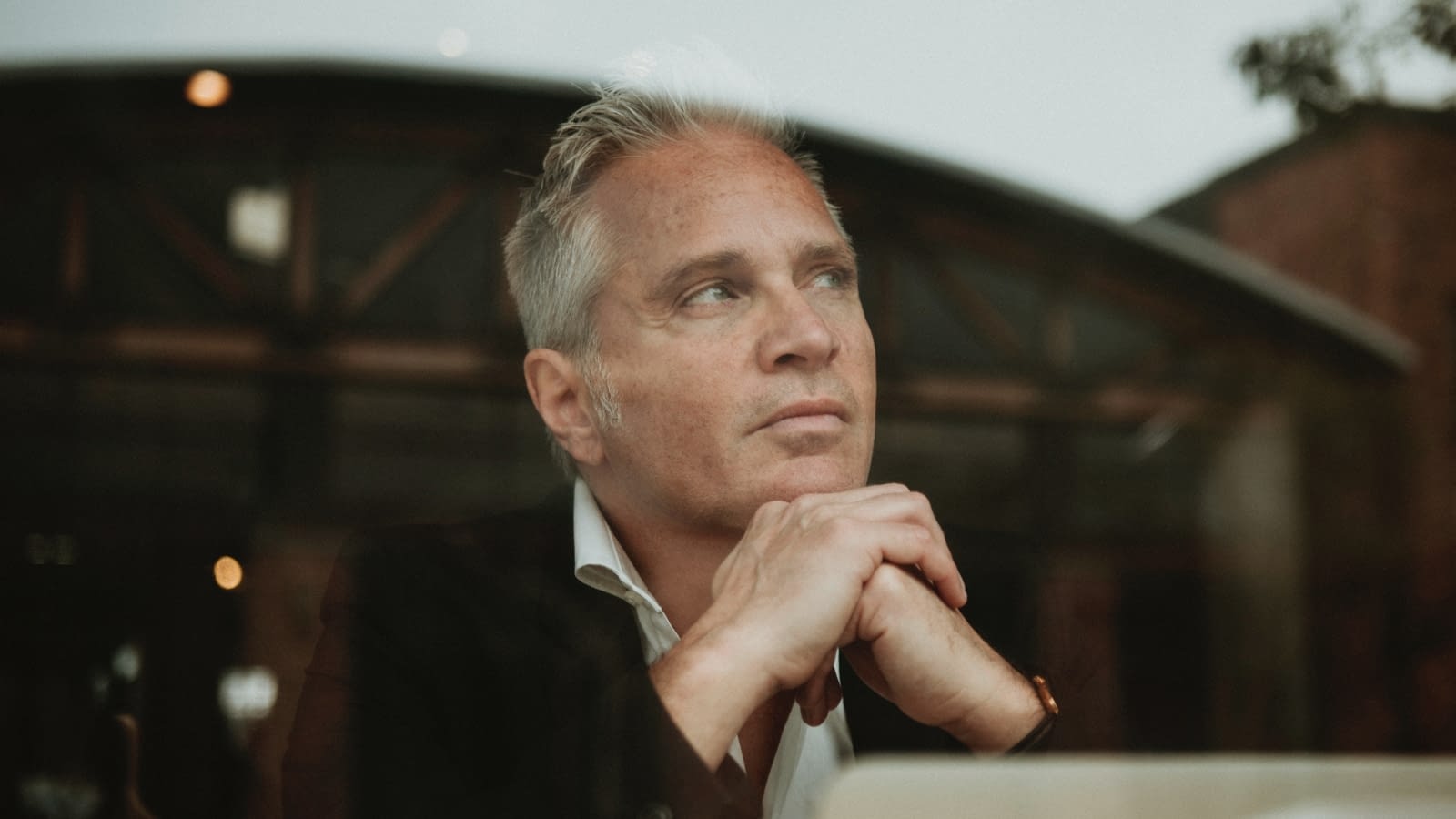 February 4 Older male business owner thinking deeply